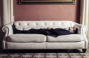 businessman lying on sofa